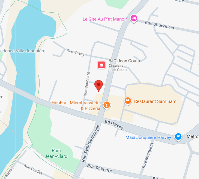 Three professionals standing and discussing documents in a modern office